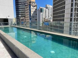 a large swimming pool on the roof of a building at Studio Moderno próximo ao Metrô in Sao Paulo