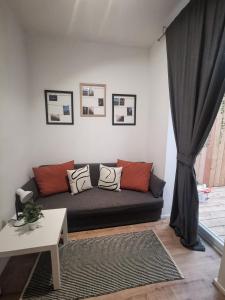 a living room with a couch and a window at Ferienwohnung Diefenbachgasse in Vienna