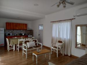 a kitchen and a living room with a table and chairs at Sol Pampa in Concordia
