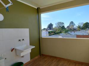 a bathroom with a sink and a large window at Sol Pampa in Concordia +45 photos