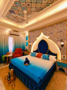 a hotel room with a bed with shoes on it at Hotel Sarang Palace - Boutique Stays in Jaipur