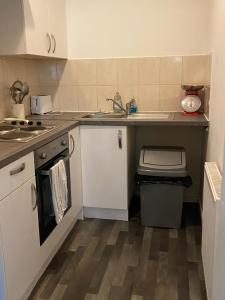 a small kitchen with a sink and a counter at The Snug on Hornby in Morecambe