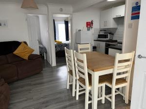 a kitchen and living room with a table and chairs at Pebble Stones in Hunstanton