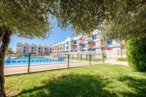 an apartment complex with a swimming pool in a park at Casa Gemma in Alcanar