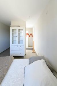 een slaapkamer met een bed en een witte kast bij Room in a farmhouse - private bathroom - by feelluxuryholidays in Vacqueyras