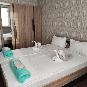 a bedroom with two beds with towels on them at DB Luxury Apartment in Veliko Tŭrnovo