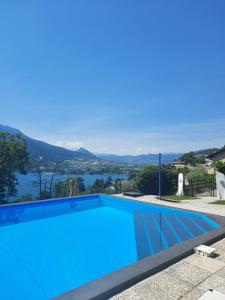 a swimming pool with a view of the water at Appartamento HAPPY DAYS (CIPAT: 022139-AT-837180) in Pergine Valsugana