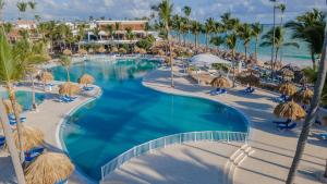 an overhead view of a resort swimming pool with palm trees at Bahia Principe Grand Bavaro - All Inclusive in Punta Cana