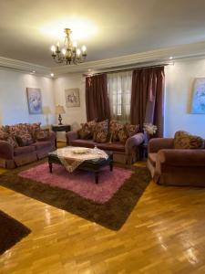 a living room with couches and a coffee table at Luxury Apartment in Port Said
