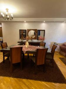 a dining room with a table and chairs and a room with a couch at Luxury Apartment in Port Said