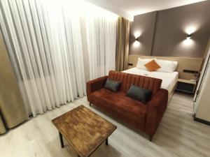 um quarto de hotel com uma cama e um sofá em NEW FALCON Palas OTEL em Istambul