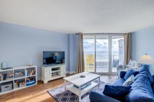 a living room with a blue couch and a tv at NTBSR3404 St Regis 3404 in North Topsail Beach