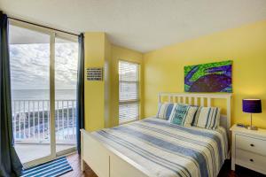 a bedroom with a bed and a view of the ocean at NTBSR3404 St Regis 3404 in North Topsail Beach +27 photos