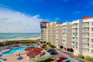 an aerial view of a resort with a pool and the ocean at NTBSR3404 St Regis 3404 in North Topsail Beach