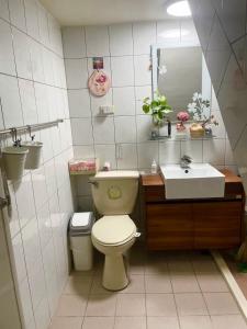 a bathroom with a toilet and a sink at Jiajia Inn in Lukang
