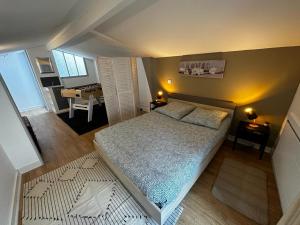 a small bedroom with a bed and a living room at Le Saint Maixent, Maison de Ville, Baby Foot, wifi in Saint-Maixent-lʼÉcole