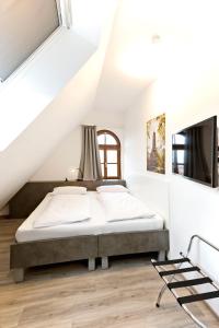 1 dormitorio con 1 cama en el ático en Vinotel Weinstrasse en Herxheim am Berg