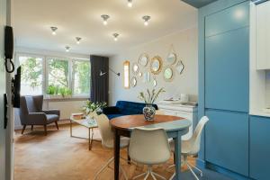 cocina y sala de estar con mesa y sillas en Project Comfort Apartament Aleje Jerozolimskie 131/12 Warszawa, en Varsovia