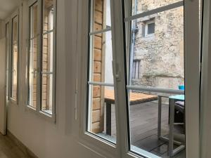 an open window with a view of a balcony at Au coeur d'Argentan in Argentan
