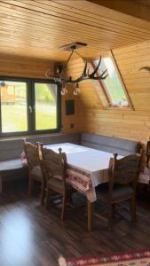 a dining room with a table and two chairs at Cabana A Toplita in Topliţa