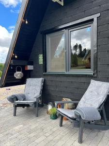two chairs sitting on a patio next to a window at Complex A Toplita in Topliţa