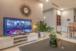 a living room with a large flat screen tv at Renovation Landmark 81 since August 2024 in Ho Chi Minh City