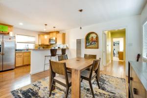 a kitchen and dining room with a wooden table and chairs at Cozy Home - 2 Mi to Walk of Fame and Griffith Park! in Los Angeles
