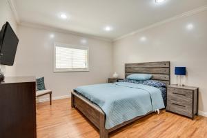 a bedroom with a bed and a television in it at Cozy Home - 2 Mi to Walk of Fame and Griffith Park! in Los Angeles