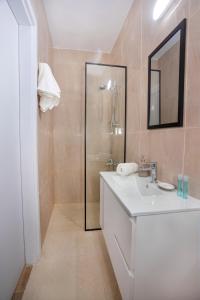 a bathroom with a white sink and a shower at STAY Zen Studio in Limassol