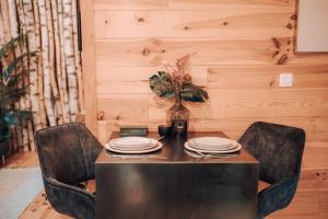 a table with plates and a vase on it at Wooden Nest in Durbuy +45 photos