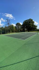 a tennis court with two tennis courts at Weavers Rest in Biddenden