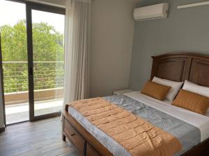 a bedroom with a bed and a large window at Dazzling and stylish 2BR Apartment in Athens