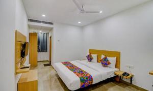 a bedroom with a bed and a television in it at FabHotel Premium Kashi in Varanasi