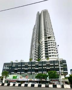 a tall white building with a sign on it at The Landmark Seaview Netflix By Blue Sky Holidays in George Town