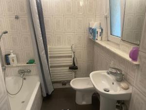 a bathroom with a sink and a toilet and a mirror at Perfect Remote-Workplace in Sunny Apartment in Myślenice