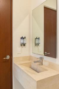 a bathroom with a sink and a mirror at Gamma Los Cabos in San José del Cabo