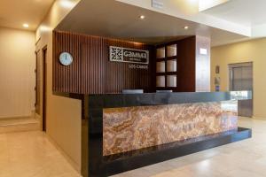 a lobby with a counter and a clock on a wall at Gamma Los Cabos in San José del Cabo