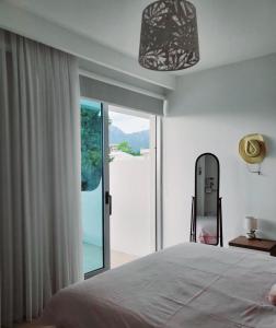 a bedroom with a bed and a large sliding glass door at Apartmani Port in Bar
