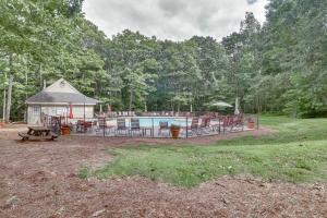 a backyard with a pool and a pavilion with tables and chairs at Ski-InandSki-Out Wintergreen Resort Condo with Patio! in Mount Torry Furnace