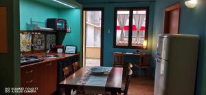 a kitchen with a table and a refrigerator at B&B Le Casette Di Lù in Agrigento