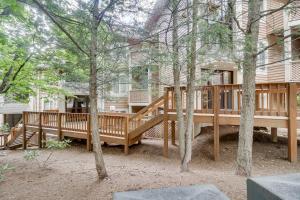 a large wooden deck in front of a house at Ski-InandSki-Out Wintergreen Resort Condo with Patio! in Mount Torry Furnace