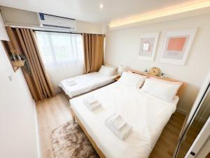 a small room with a bed and a window at Happiness sleep C3 in Ban Bang Phang