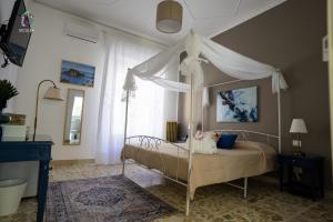 a bedroom with a bed with a canopy at Siculea Home in Adrano