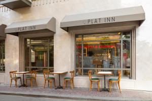 a group of tables and chairs in front of a store at Plat Inn Hotel Taksim in Istanbul