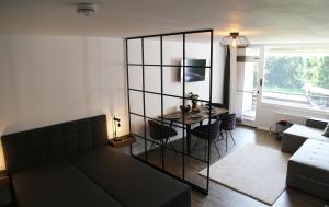 a living room with a couch and a table with chairs at Kampenwand am Chiemsee in Prien am Chiemsee