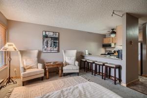 a room with a kitchen with chairs and a table at Blazing Saddles #122 in Breckenridge