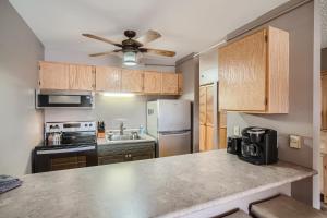 a kitchen with wooden cabinets and a counter top at Blazing Saddles #122 in Breckenridge