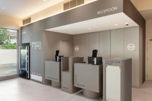 a reception area of a building with a reception desk at B&B HOTEL Lleida in Lleida