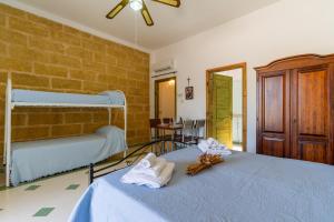a bedroom with two beds with towels on them at Domus mea salento Arazzo Blu in Ugento