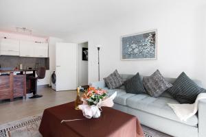 a living room with a couch and a table at Lovely 2 bedroom condo with pool in Vallauris